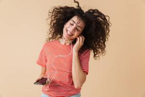 emotional happy excited young curly woman 2JBV3GN